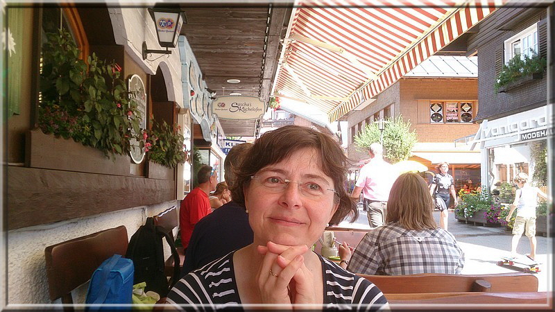 Karin wartet auf ihr Mittagessen. Im Hintergrund der Schoko-Laden und im Obergeschoss der "Kaisergarten".